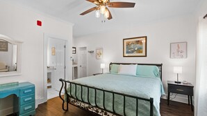 A bedroom with a bed, a ceiling fan, a dresser, and a nightstand. - Little Inn on Main 214 West Main Street (Washington)