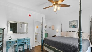 A bedroom with a four-poster bed, a ceiling fan, a dresser, and a desk. - Little Inn on Main 214 West Main Street (Washington)