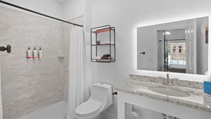 A modern bathroom with a shower, toilet, and vanity. - Little Inn on Main 214 West Main Street (Washington)