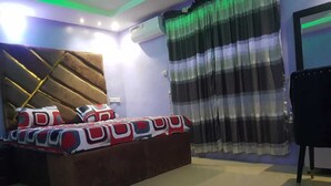 A bedroom with a bed, a headboard, a window with curtains, and a chair. - Enjoy this unique, lavishly furnished 1-bed apartment with "Open Kitchen Design" (Lagos)