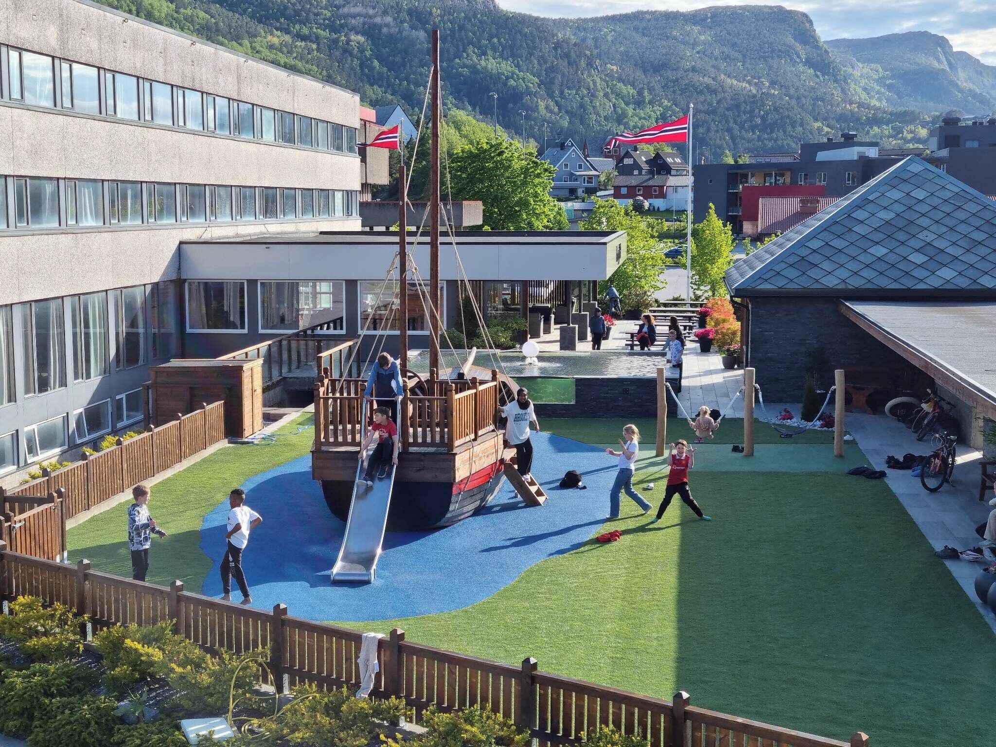 A playground with a slide, swings, and a climbing structure.