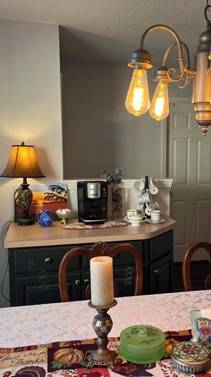 Enjoy a warm meal in this inviting dining area, complete with a beautifully set table and a vintage atmosphere.