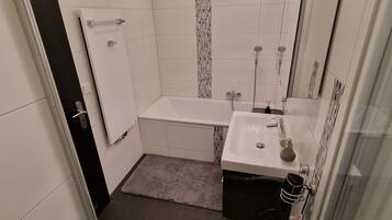 Shower, hair dryer, towels, toilet paper