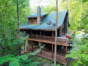 A cabin with a stone chimney, multiple decks, and satellite dishes. - Applewood Lodge | Hocking Hills, Hot Tub, Fire Pit (Logan)