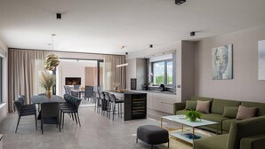 A modern living room with a green sofa, a coffee table, and a dining area with chairs and a table. - Lovely home in Benkovac with sauna (Benkovac)