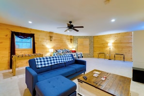 Relax in this inviting room with a sofa, ottoman, and coffee table, plus a foosball table for entertainment.