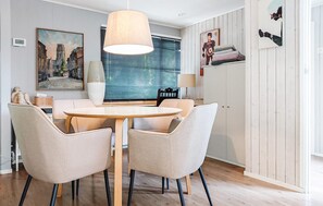 A dining area with a round table, four chairs, and a hanging light fixture. - Gorgeous home in Vorden with WiFi (Vorden)