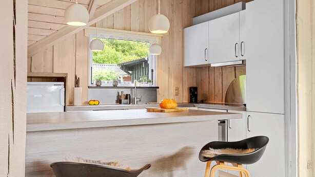 A modern kitchen with wooden cabinets, a white refrigerator, and a large window. - Awesome home in Hejls with WiFi (Hejls)