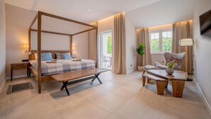 A modern bedroom with a four-poster bed, a small desk, a chair, and a large window with curtains. - 4 bedroom beautiful home in Klimno (Klimno)