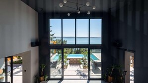 A modern interior with a large window overlooking a pool and a view of the sea. - Villa Beatrice (Soho) (Starigrad)