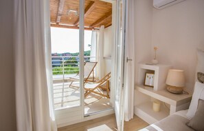 Relax on the balcony with a single chair, or enjoy the simple living area with a console table and lamp.