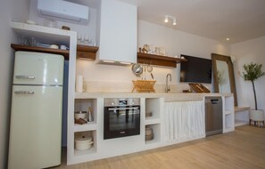 Enjoy cooking in this well-equipped kitchen with a refrigerator, oven, and dishwasher.