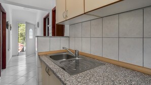 A kitchen with a granite countertop, stainless steel sink, and beige cabinets. - 3 bedroom beautiful apartment in Baric Draga (Baric Draga)