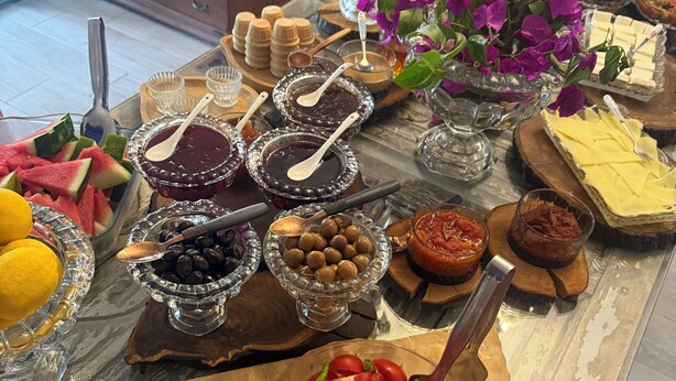 A buffet table with various food items and utensils. - Masal Küçükköy Otel (Ayvalik)