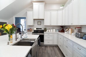 Fridge, microwave, coffee/tea maker, cookware/dishes/utensils