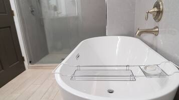 Bathtub, eco-friendly toiletries, hair dryer, towels