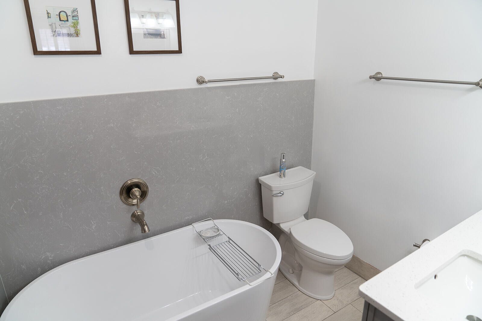 A bathroom with a bathtub, toilet, and sink.