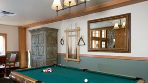A pool table with balls, a mirror, and a wooden cabinet in a room with wooden beams and a window. - R&R for 6 | Prime Location + Exclusive Privacy! (Keystone)