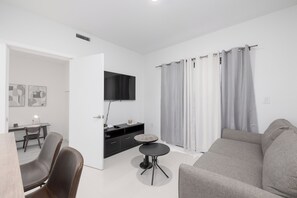Relax in this inviting living room with a comfortable sofa, coffee table, and TV for entertainment.