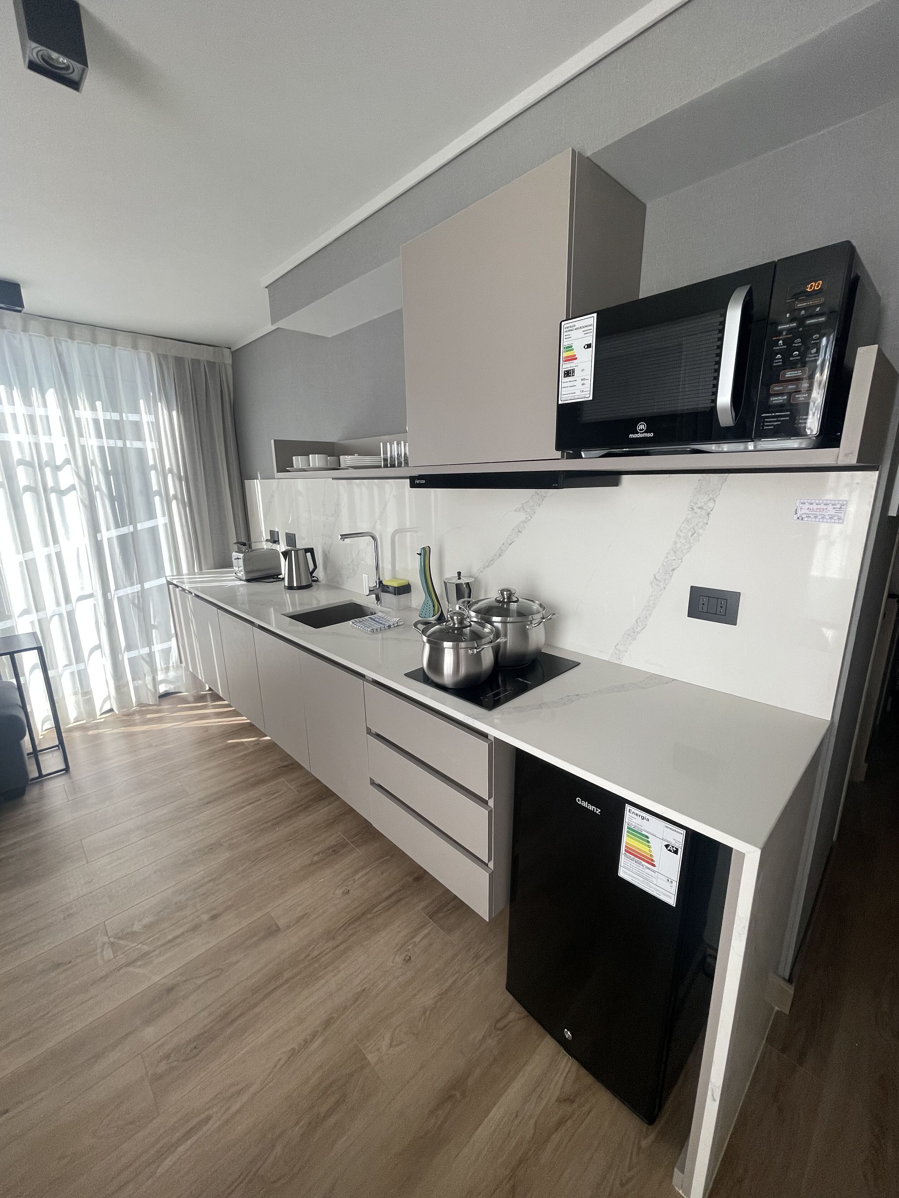 A modern kitchen with a microwave, stove, and dishwasher.
