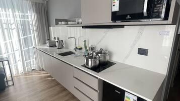 A modern kitchen with a microwave, stove, and dishwasher.