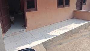 A building with a tiled entrance and a small porch area.