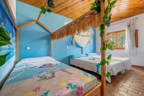 A room with two beds, a wooden ceiling, and a mural on the wall.