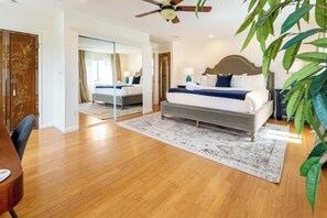 Relax in this serene bedroom with a large bed, wooden headboard, and a spacious area for a bedside table and lamps.