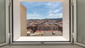 A window with a view of a cityscape, including buildings and a mountain range. - Holiday Home 'Parraga' with Mountain View, Private Terrace and Balcony (Cehejín)