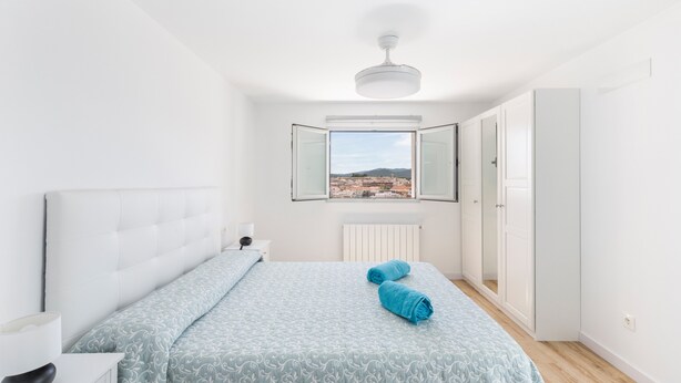 A bedroom with a bed, a window with a view, a ceiling fan, and a wardrobe. - Holiday Home 'Parraga' with Mountain View, Private Terrace and Balcony (Cehejín)