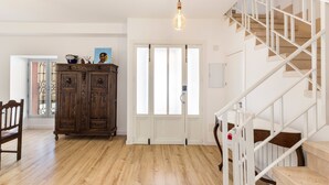 A staircase with a white railing, a wooden cabinet with intricate carvings, and a light fixture. - Holiday Home 'Parraga' with Mountain View, Private Terrace and Balcony (Cehejín)