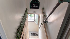 A staircase with a sign reading 'Place de la Concorde' and a view of the outside.