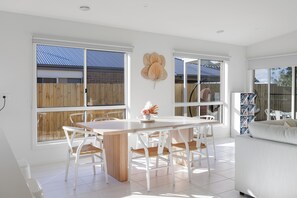 Enjoy meals in this spacious dining area with a large table and comfortable seating for all.