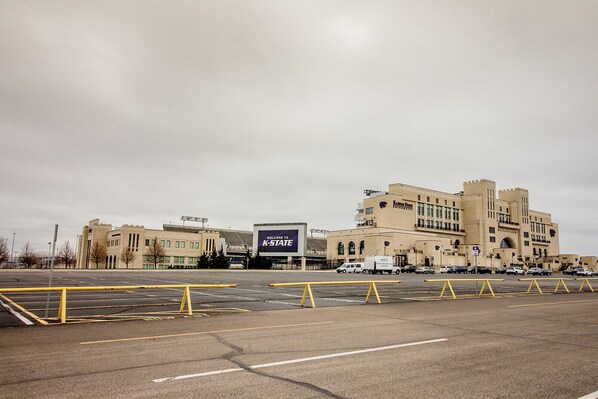 A large building with a sign reading "Welcome to K-State."