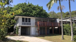 A two-story house with a covered porch and a garage. - Endeavour Reach (Cooktown)