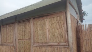 A building with a bamboo exterior and a white awning.