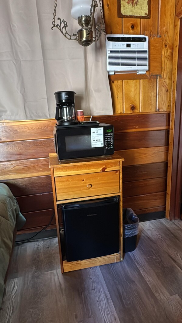 A compact kitchenette with a microwave, coffee maker, and small refrigerator. - Toiyabe Motel (Coleville)