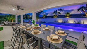 A dining area with a pool, outdoor seating, and a ceiling fan. - Palm Desert Home w/Pool & Spa, Walk to Ironwood Park (Palm Desert)