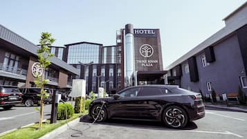 A modern building with a sign reading "TAUKE KHAN PLAZA HOTEL".