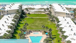 A resort with a pool, beach, and multiple buildings.