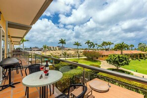 Enjoy a serene view of the well-maintained garden and residential area from this balcony.