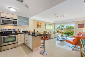 Enjoy cooking in the well-lit kitchen with a central island, stainless steel range, and large oven.