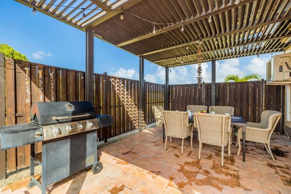 Enjoy al fresco dining on the patio with a grill station and comfortable wicker furniture.