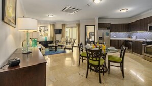 A modern hotel room with a dining area, kitchen, and a living space. - One Bedroom Condo w Amazing Views Luxurycomplex (Noord)