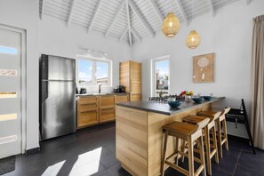 Enjoy cooking in this well-equipped kitchen with a central island and bar stools.