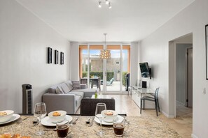 Relax in a comfortable seating area with a sofa and dining table, perfect for meals and relaxation.