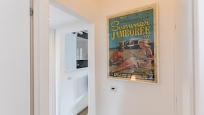 A hallway with a vintage poster advertising 'Summer Jamboree #11' at the Senigallia Italy venue, including dates and contact information. - Bellarmino 21 in Milano (Milan)