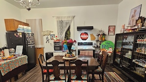 A cozy kitchen with a dining table, chairs, and a refrigerator. - Athensmusic Gem 1 mile from Town (Athens)