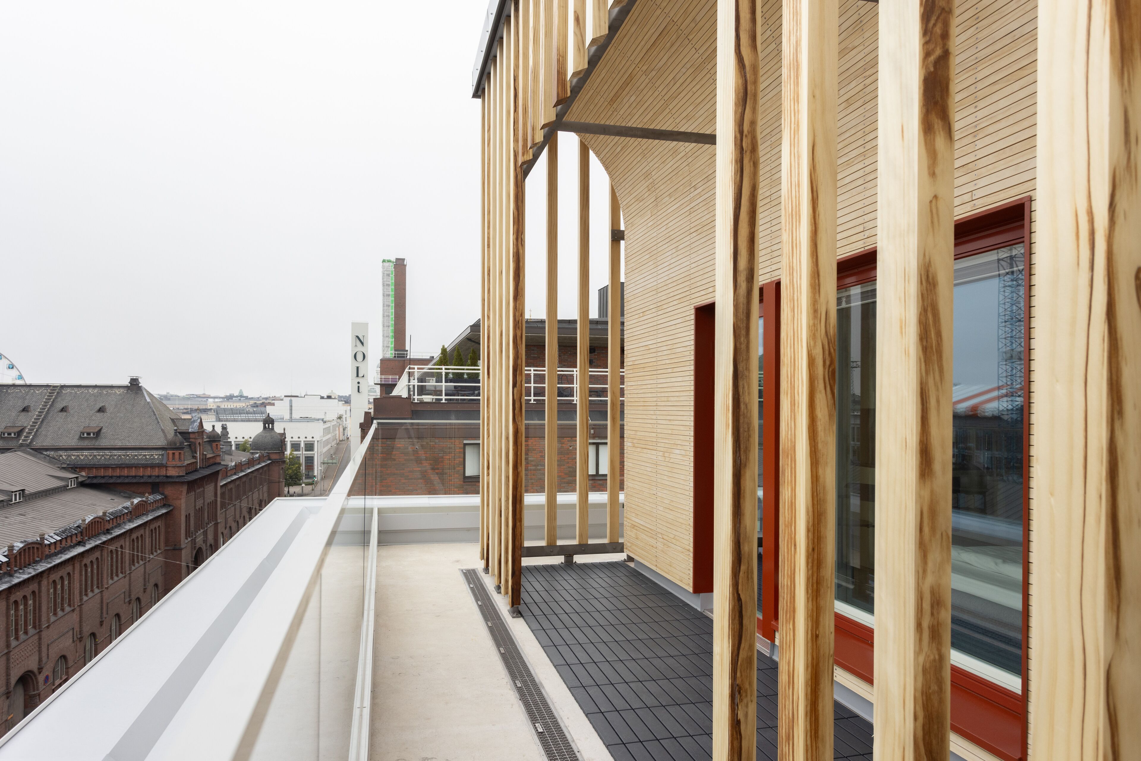 A modern building with wooden exterior panels and large windows.