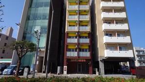 A multi-story building with a modern glass facade and a sign for B8tv. - BiBi Hotel Cosmos Shintoshin (Naha)